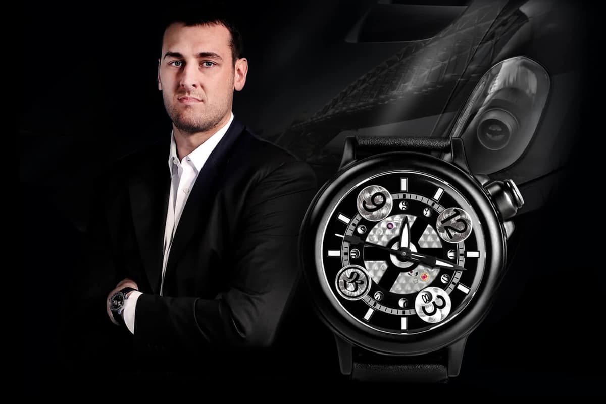 Andrew Bogut wearing a suit with a Bausele limited edition watch, featuring a black dial and unique design elements.