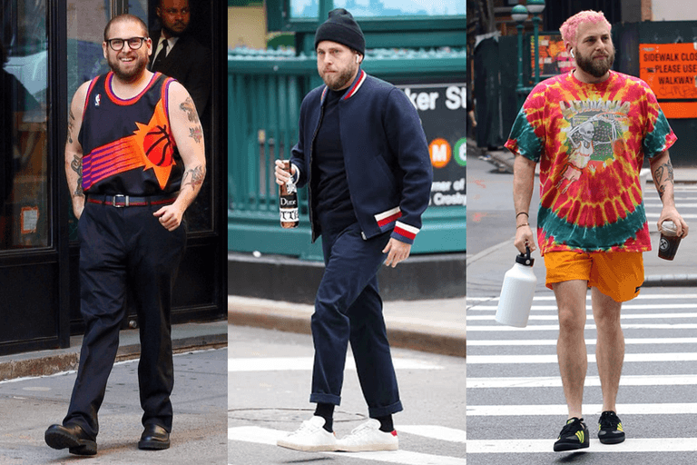 Jonah Hill wearing a basketball jersey, a beanie with a bomber jacket, and tie-dye shirt with orange shorts.