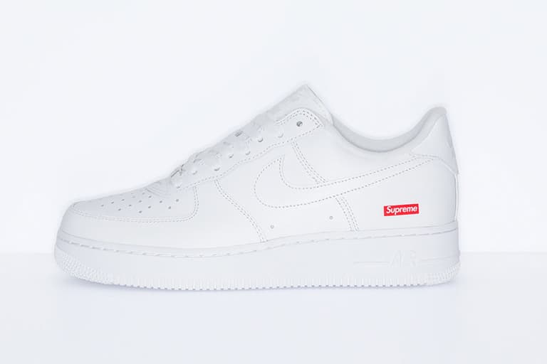 Nike x Supreme Air Force 1 sneaker in white with red Supreme logo on heel, side view.
