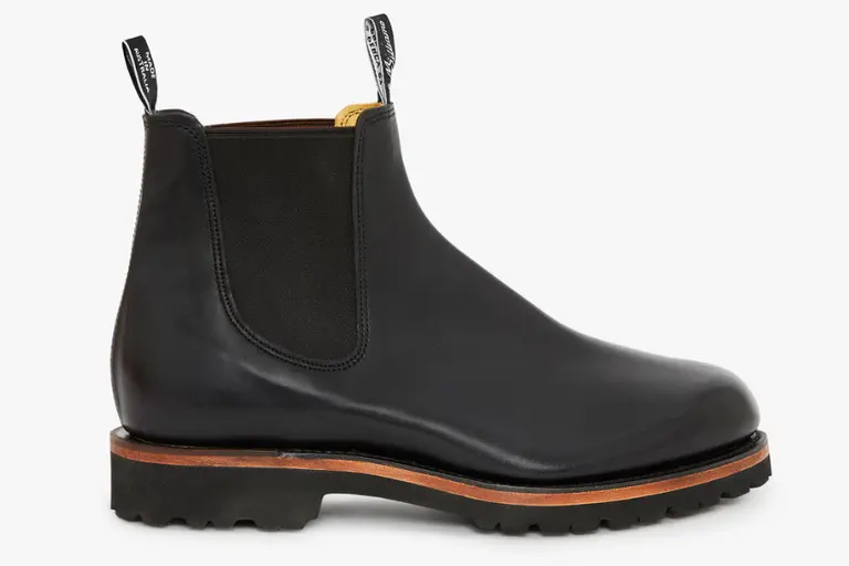 R.M. Williams Urban Turnout Boot in black leather with rugged sole, side profile on white background.