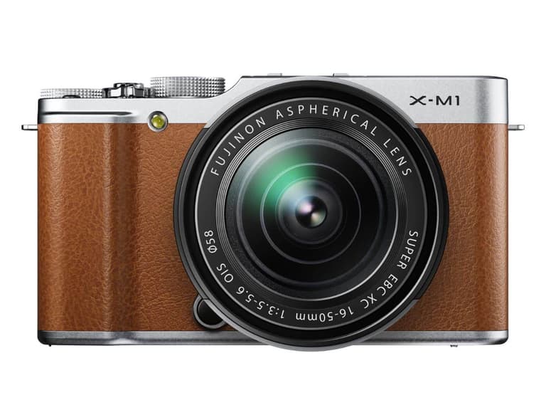 Fujifilm X-M1 mirrorless camera with brown leather finish and 16-50mm lens, front view.