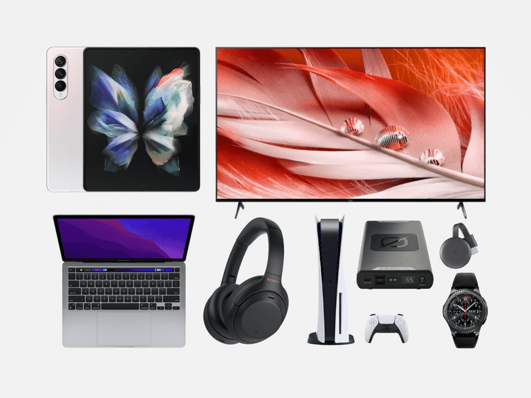 Samsung Galaxy Z Fold, MacBook, Sony headphones, PlayStation 5, smartwatch, and TV on white background.