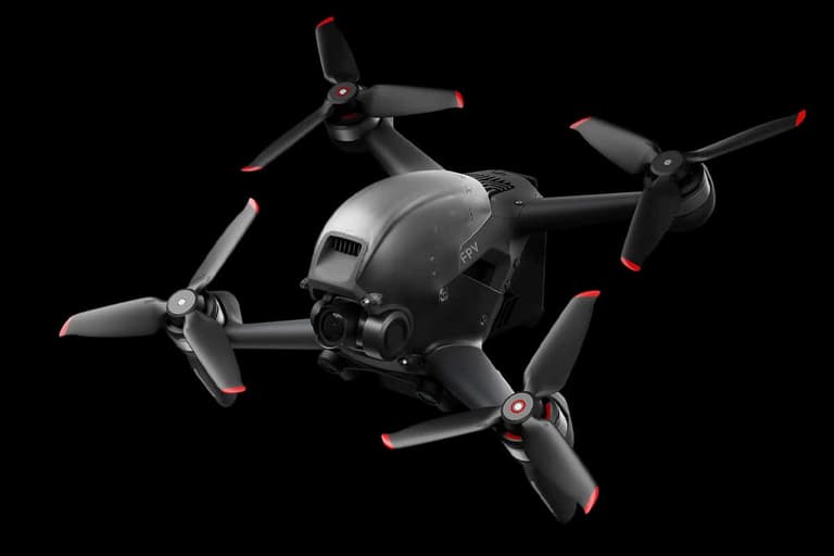 DJI FPV drone with sleek black design and red-tipped propellers against a black background.