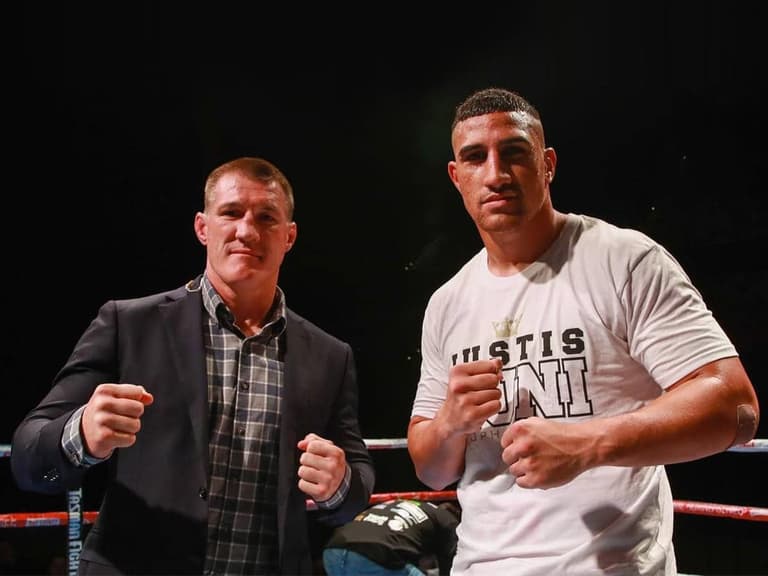 Former NRL star Paul Gallen and Justis Huni posing inside the boxing ring