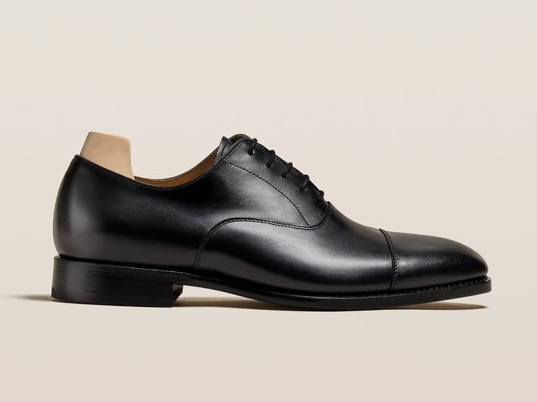 Appelviken Black Calf Oxford shoe in side profile, showcasing a sleek leather finish and classic cap toe design.