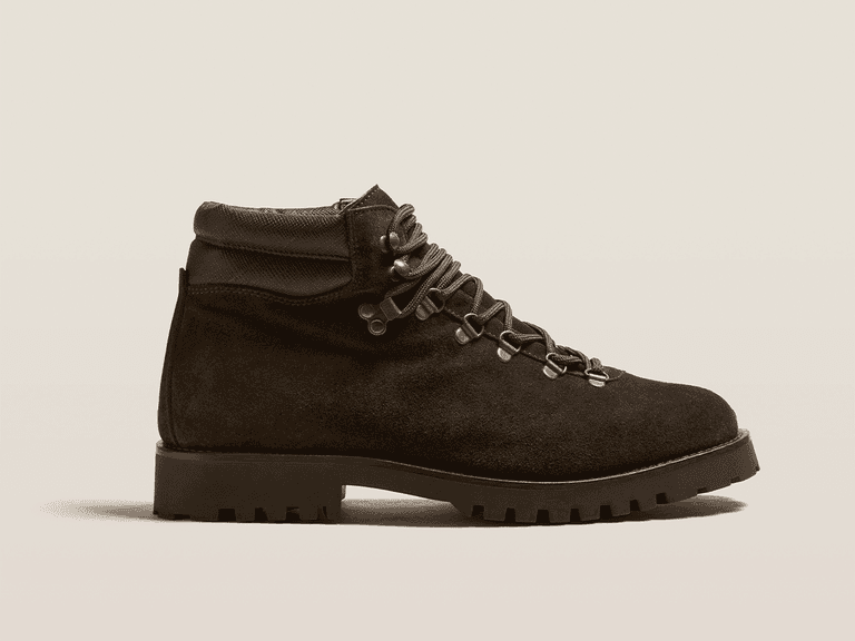 Myrqvist Duved boot in dark brown suede, side view showcasing rugged sole and metal eyelets.
