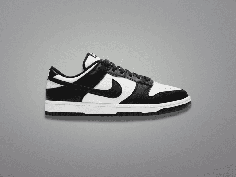 Nike Dunk Low Panda sneaker in black and white, side view on a grey background.