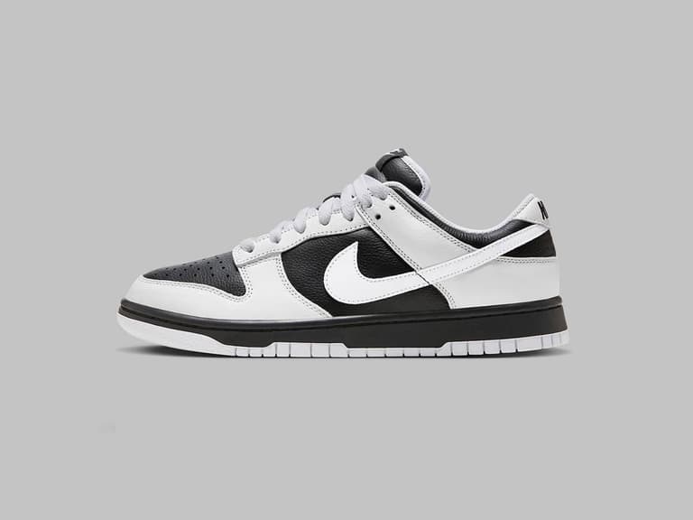 Nike Dunk Low Reverse Panda sneaker in black and white, side view on a grey background.