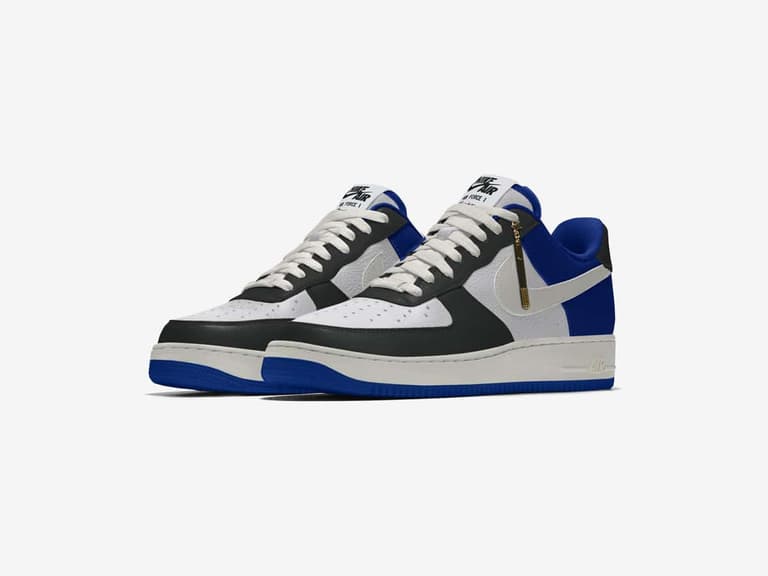 Nike Air Force 1 sneakers in custom black, white, and blue design with gold accents on a white background.