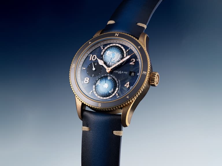 Montblanc 1858 Geosphere watch with blue dial and bronze case on gradient background.