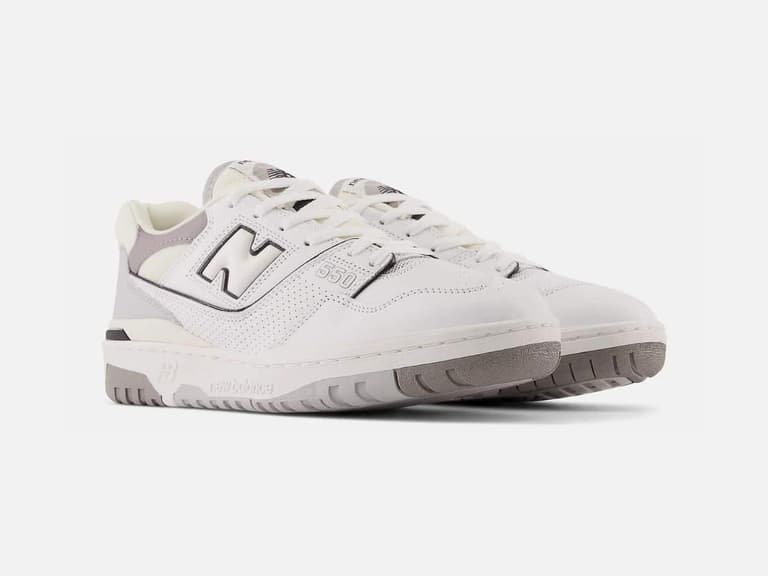 New Balance 550 sneakers in white and grey, angled view on a plain white background.