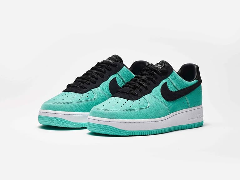 Tiffany & Co. x Nike Air Force 1 sneakers in teal with black accents on a white background.