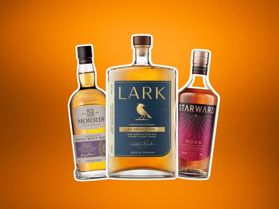 Lark, Morris, and Starward whiskey bottles on orange background.