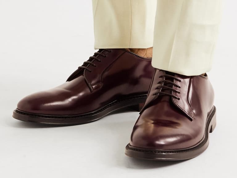 Officine Creative Hopkins Leather Derby Shoes in burgundy worn with cream trousers.