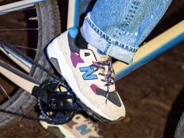 Levi's x New Balance MT580 sneaker in beige and blue on foot near a bicycle pedal.