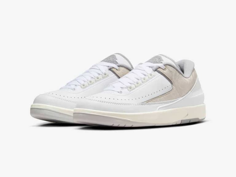 Nike Air Jordan 2 Low sneakers in white and grey with python-textured accents, displayed on a white background.