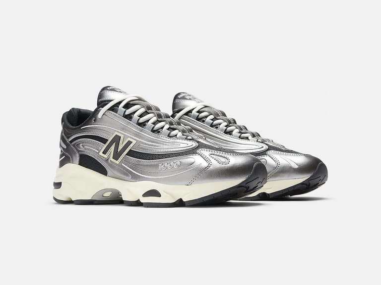 New Balance 1000 sneakers in silver metallic with black and white accents on a white background.