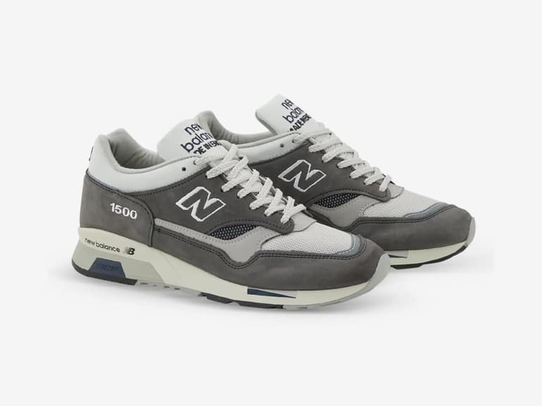 New Balance 1500 sneakers in grey and white, featuring mesh and suede materials, angled on a white background.