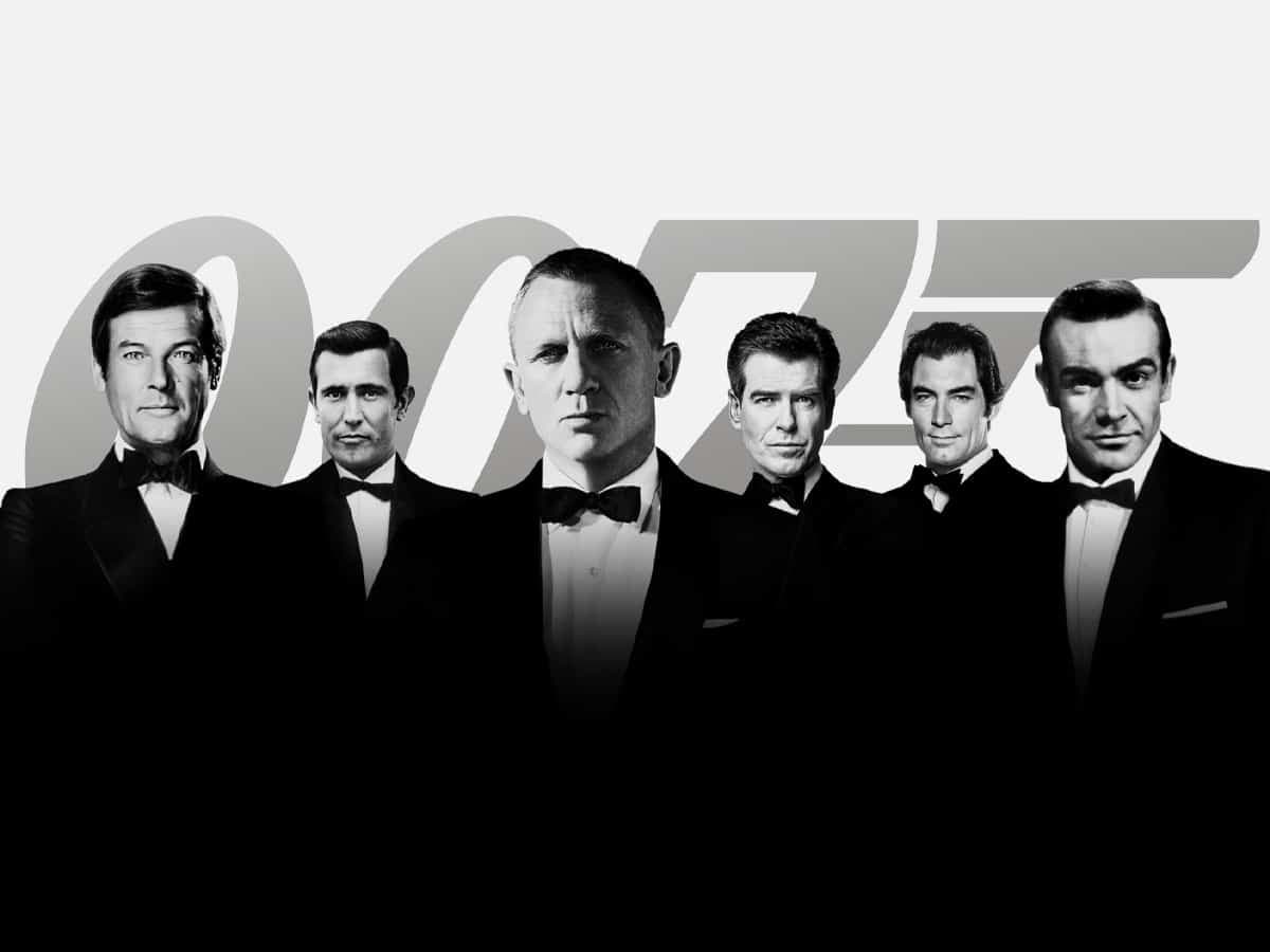 James Bond actors in tuxedos against a large 007 logo backdrop.