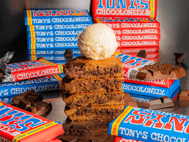Gelato Messina dessert with Tony's Chocolonely bars, featuring stacked cookies topped with vanilla ice cream.