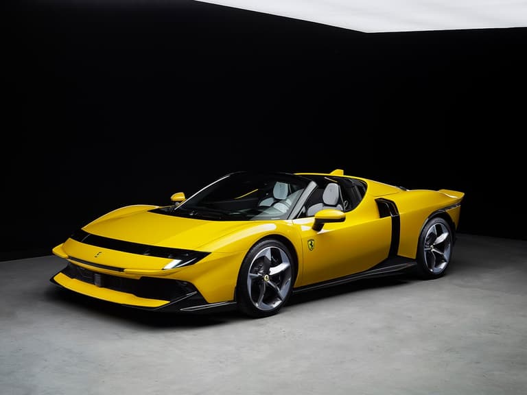 Ferrari 849 Testarossa Spider in vibrant yellow under studio lighting.