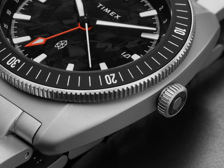 Timex Automatic GMT Nocturne Edition watch with black dial, red GMT hand, and stainless steel case.