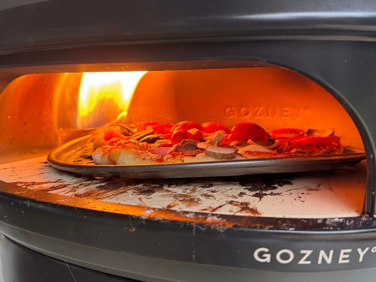 Gozney Arc Lite lateral rolling flame cooking a 12-inch Neapolitan pizza