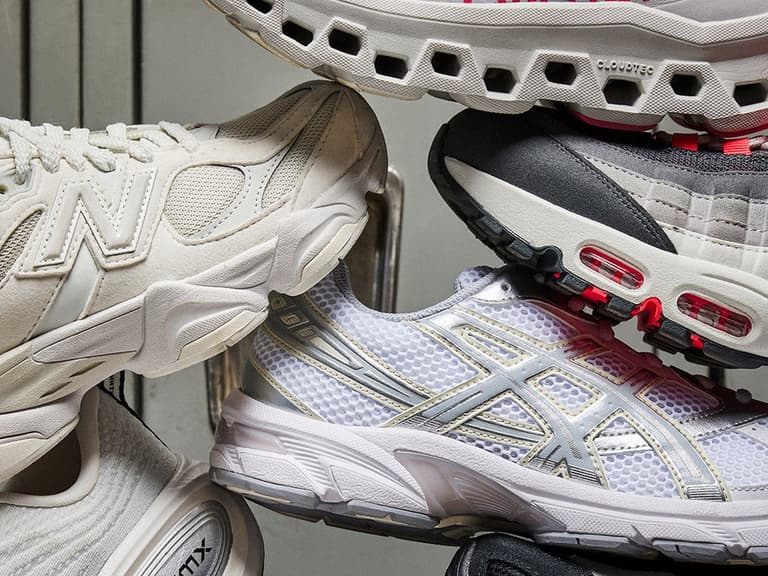 A lineup of Foot Locker sale sneakers from brands including Nike, Jordan and New Balance arranged on a plain studio background. (4 of 4)