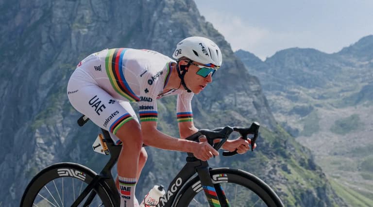 Tadej Pogacar climbing in the world champion's jersey for UAE Team Emirates XRG at the Tour de France