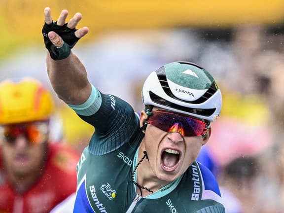A professional cyclist celebrates a stage win at the Tour de France