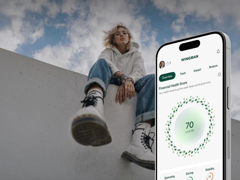 Wingman app showing a Financial Health Score of 70 out of 100 on a phone, with a young woman sitting on a concrete wall behind it