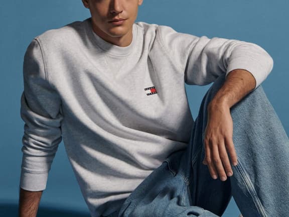 A Tommy Hilfiger apparel campaign scene showing men's and women's clothing, shoes and accessories from the seasonal range.