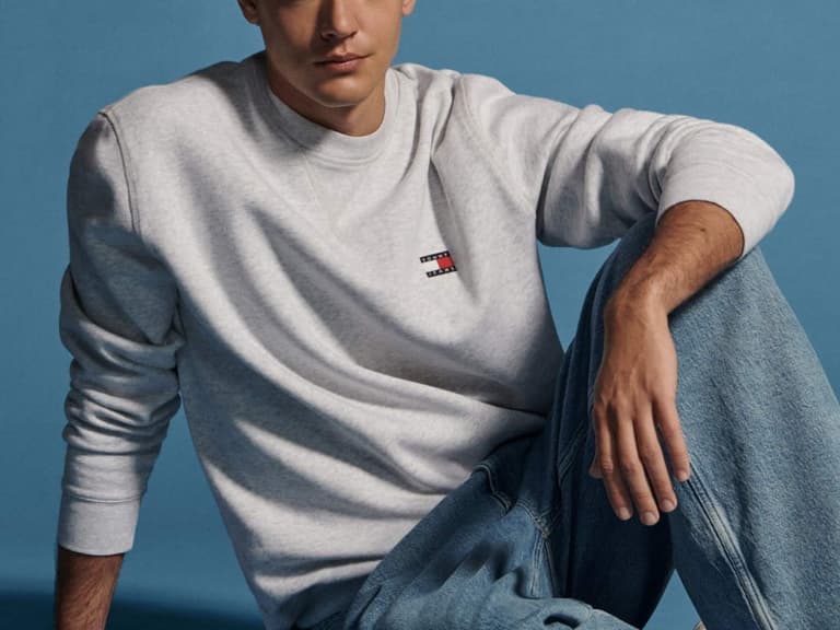 A Tommy Hilfiger apparel campaign scene showing men's and women's clothing, shoes and accessories from the seasonal range.