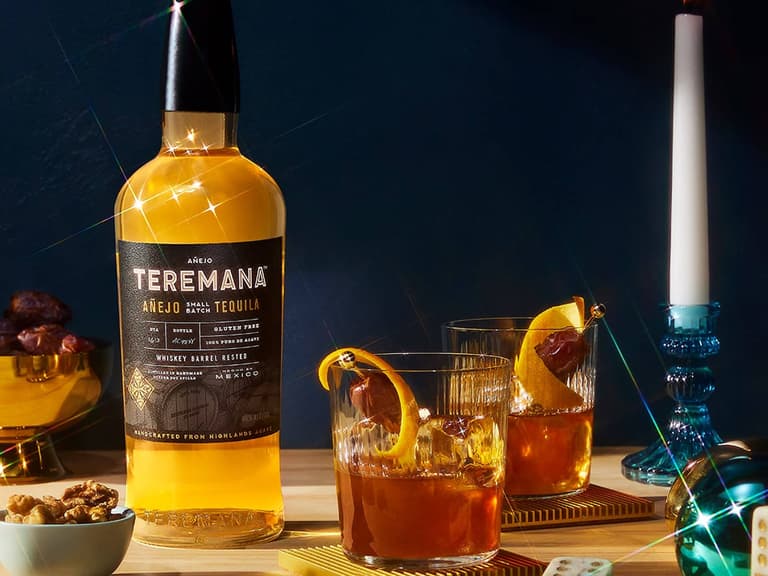 Three bottles of Teremana small batch tequila arranged together against a warm, earthy backdrop.